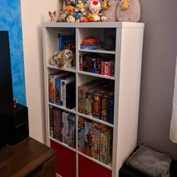 An open cupboard with various board games