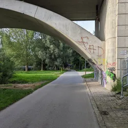 A road under a bridge with graffiti on it at the Uferpromenade in Fürth