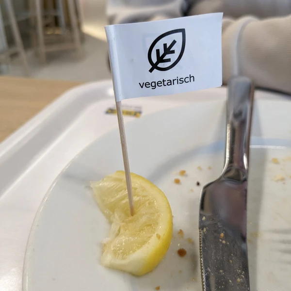 A toothpick flag labelled vegetarian on a slice of lemon